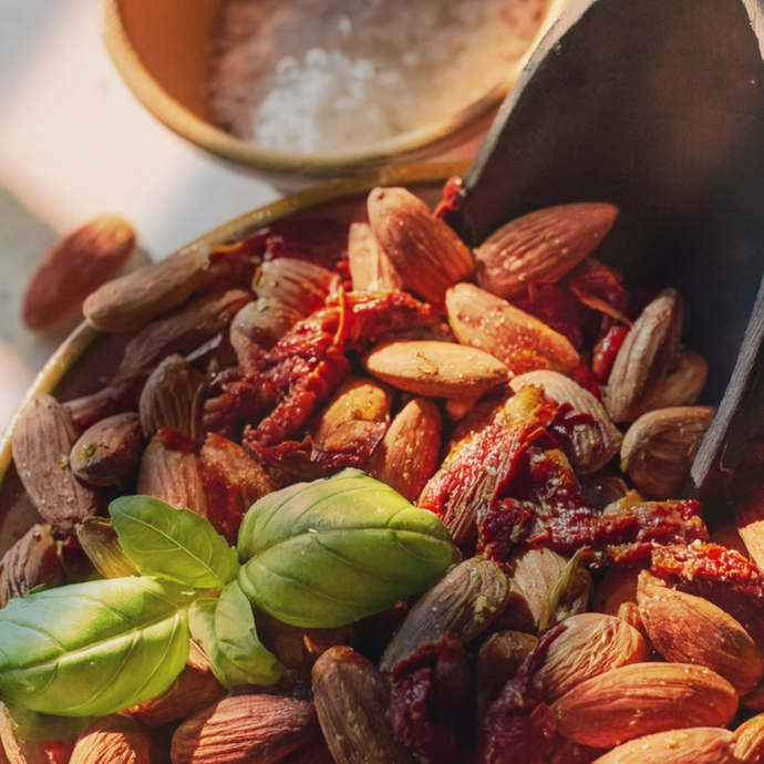 A bowl with Almonds, Sundried Tomatoes, and Basil.