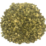 A pile of pumpkin seeds with a white background