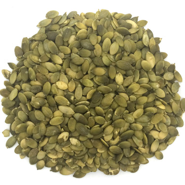 A pile of pumpkin seeds with a white background