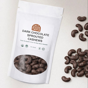 Bag of dark chocolate sprouted cashews on a light background