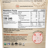 Back of Healthy Truth mango slices resealable 3oz package showing nutrition facts, ingredient list, and certifications. Highlights include 'Just Fruit' with no added sugars or preservatives, and ingredients listed as organic dried mango slices. Nutrition facts show 130 calories per 1.65oz serving, 27g sugars, and 7g fiber. Certifications at the bottom include USDA Organic, Gluten Free, Plant Based, Dairy Free, and Raw. A red QR code for learning more is also displayed.