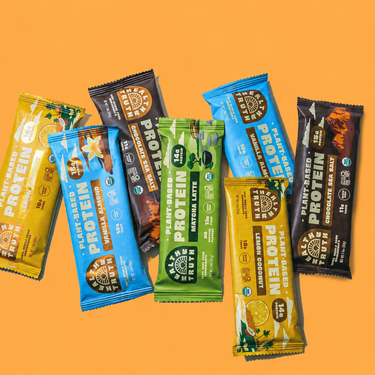 Assorted protein bars on an orange background