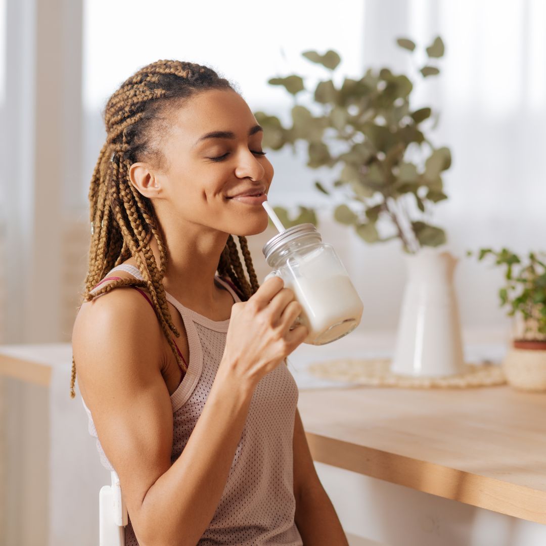 woman drinking recovery drink