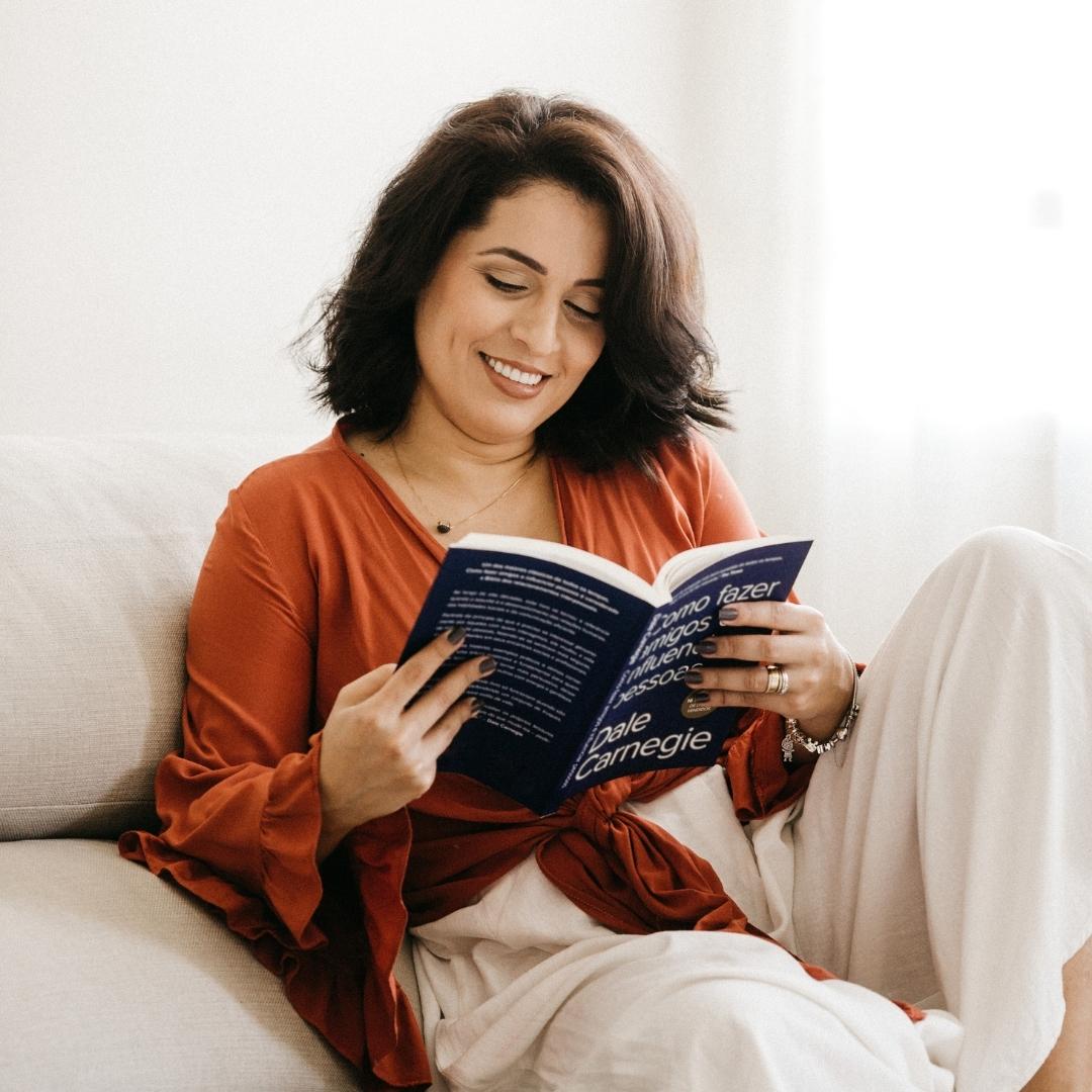 Woman smiling while reading a book