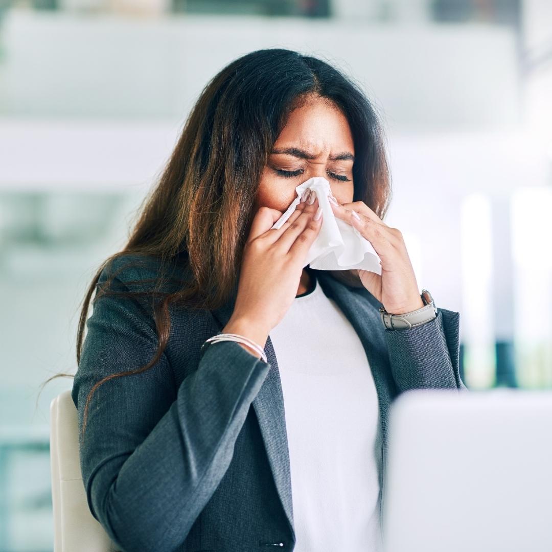 Woman blowing her nose