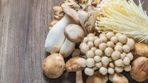 Variety of mushrooms on a wood background