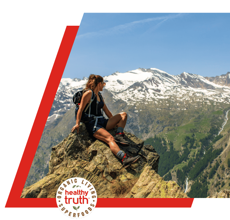 woman sits on a mountaintop